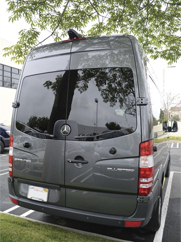 The rear doors of all the passenger vans are held open by heavy-duty ...